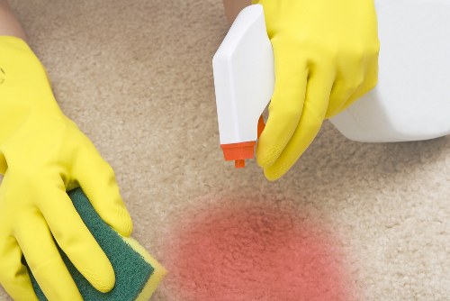 Professional carpets cleaner in Fulham treating a living room carpet