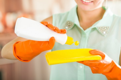 Cleaner tidying a modern Fulham apartment during a one off clean